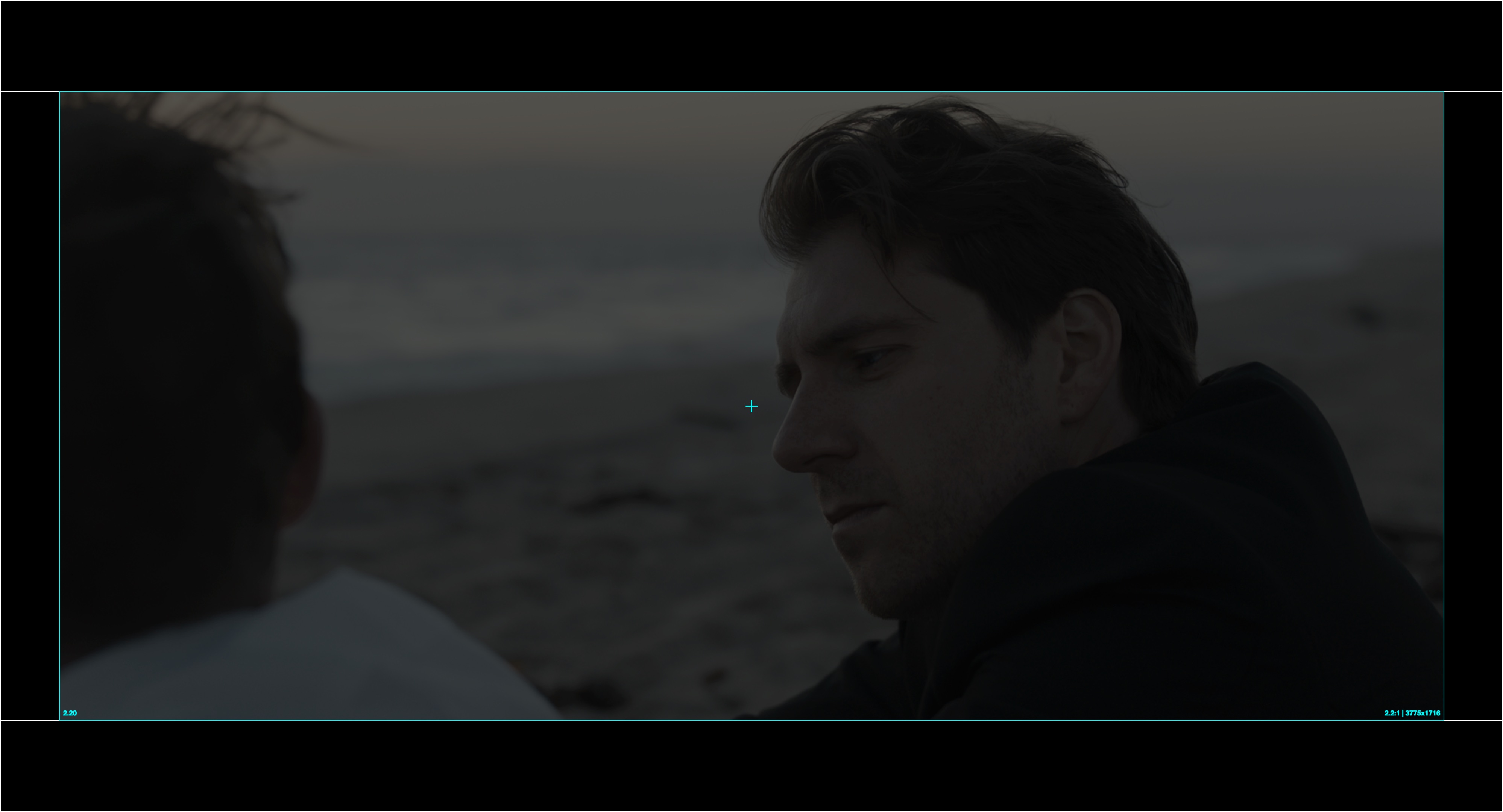 A 2.20:1 active image pillarboxed inside a Scope DCP and projected on a Flat-native screen, leaving black bars on all four sides.